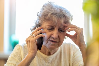 Sad older women on phone