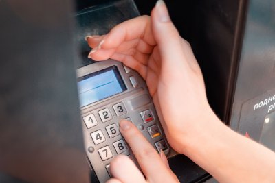 Hands at an ATM